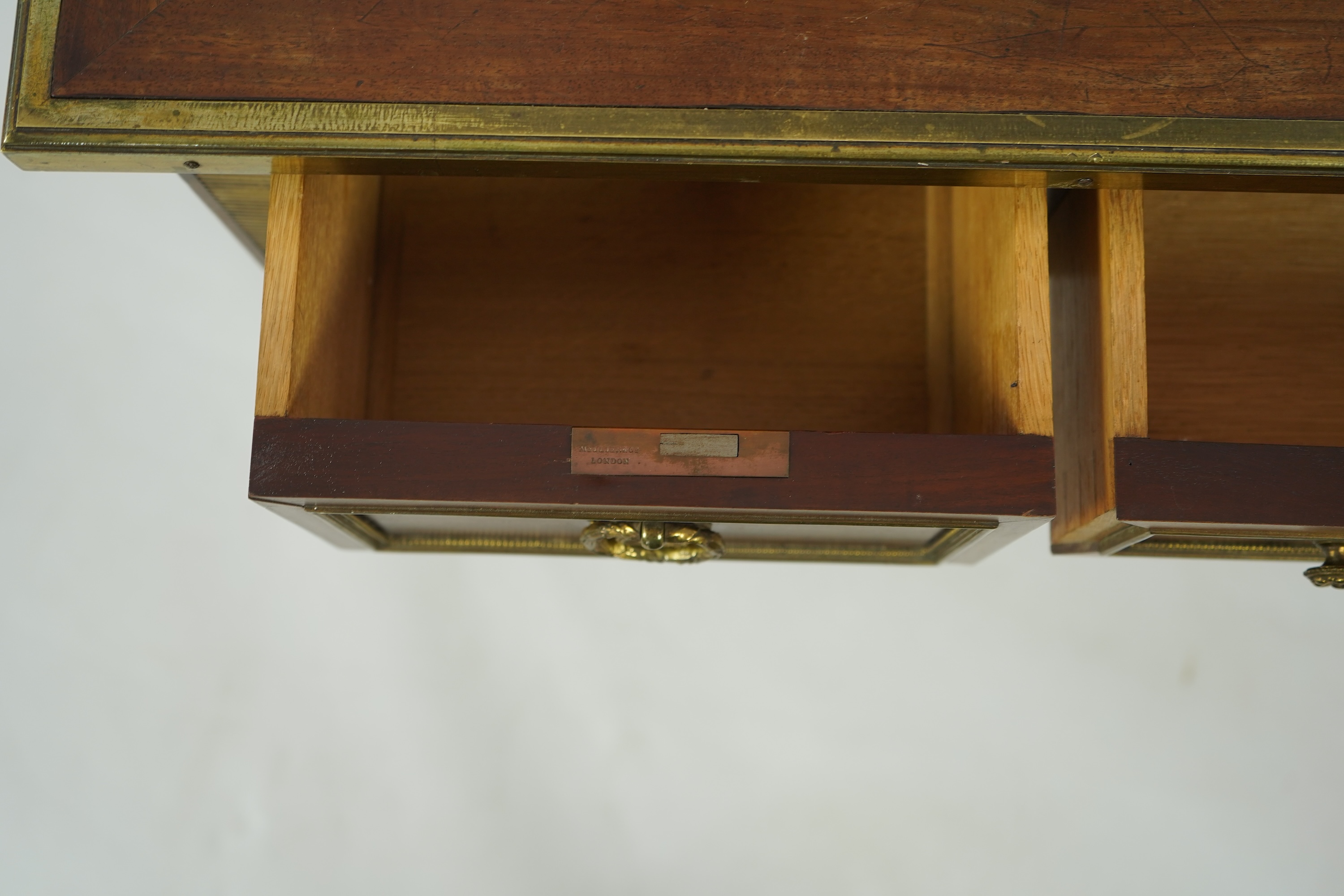 An early 20th century Louis XVI style brass mounted mahogany writing table